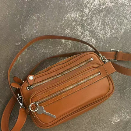 Black Vegan Leather Crescent Crossbody Bag – Adjustable Strap, Multiple Zipper Pockets, Sleek Silver Accents